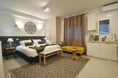a hotel room with a bed and a kitchen at Window to...Acropolis! in Athens