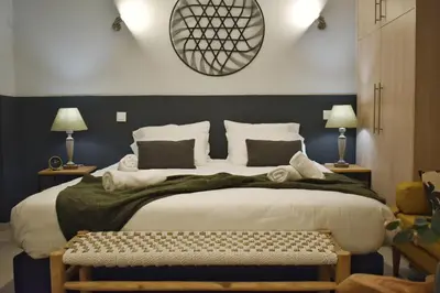 a bedroom with a large bed and two lamps at Window to...Acropolis! in Athens