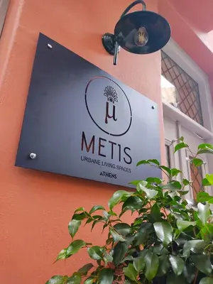 a sign on the side of a building at Metis Urbane Living Spaces in Athens