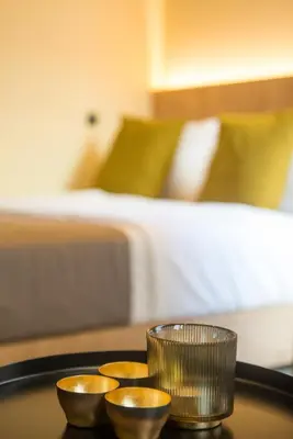 three gold bowls on a table in a room with a bed at Metis Urbane Living Spaces in Athens