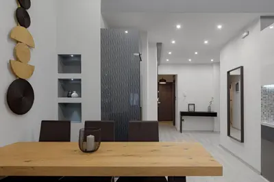 a dining room with a wooden table and chairs at Acropolis Deluxe Apartment in Athens