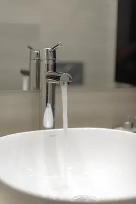 a sink with water running from a faucet at Acropolis Deluxe Apartment in Athens