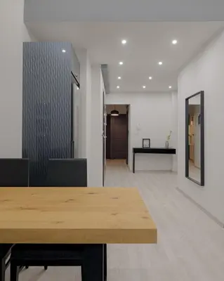 an empty office with a wooden table and a hallway at Acropolis Deluxe Apartment in Athens