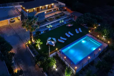 an overhead view of a swimming pool at night at Villa Artemida Vravrona in Vravrona