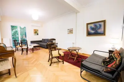 a living room with a couch and a table at Klokkaris Stays Athens in Athens