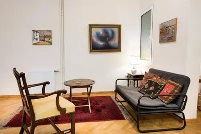 a living room with a couch and a table at Klokkaris Stays Athens in Athens