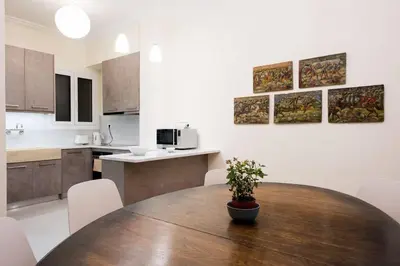 a kitchen with a wooden table with a potted plant at Klokkaris Stays Athens in Athens