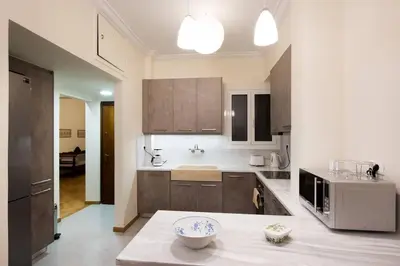 a kitchen with wooden cabinets and a bowl on a table at Klokkaris Stays Athens in Athens