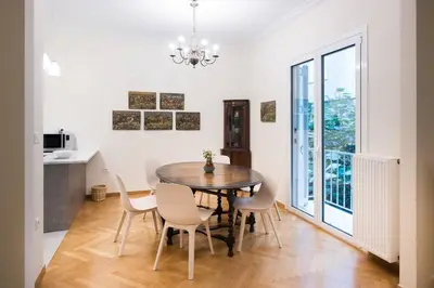 a dining room with a table and chairs at Klokkaris Stays Athens in Athens