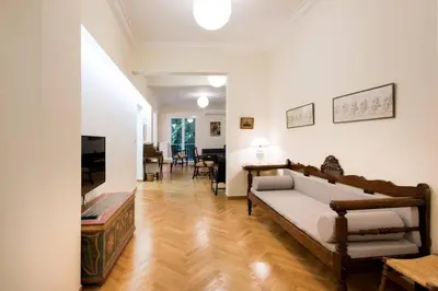 a living room with a couch and a television at Klokkaris Stays Athens in Athens