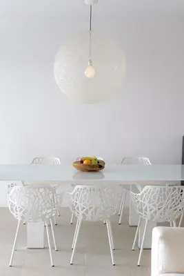a white dining room with a white table and chairs at Luxurious Beachfront Villa Maira in Aghia Marina