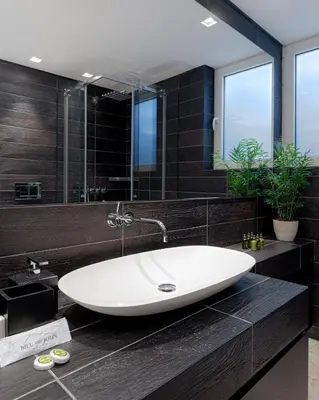 a bathroom with a large white tub in a black bathroom at Luxurious Beachfront Villa Maira in Aghia Marina