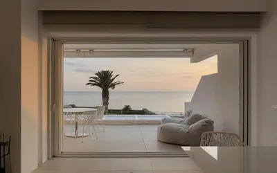 a living room with a view of the ocean at Luxurious Beachfront Villa Maira in Aghia Marina