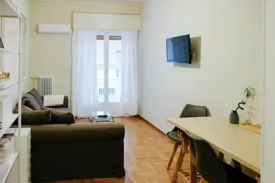 a living room with a couch and a table at Newly Renovated Athenian Apt with Balcony in Athens