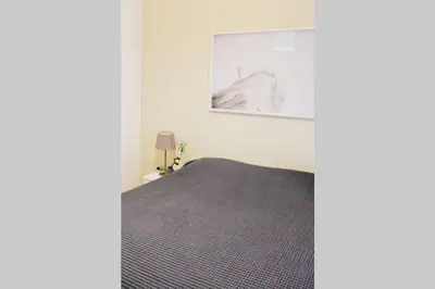 a bedroom with a bed and a picture on the wall at Newly Renovated Athenian Apt with Balcony in Athens