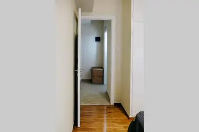 a hallway with a door open to a room at Newly Renovated Athenian Apt with Balcony in Athens