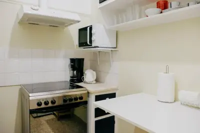 a small kitchen with a stove and a counter at Newly Renovated Athenian Apt with Balcony in Athens