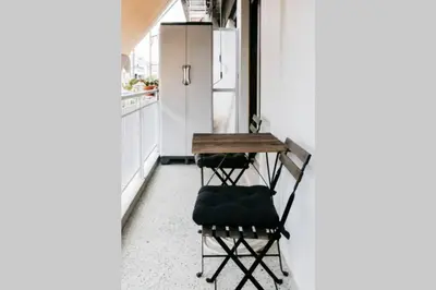 a small kitchen with a table and a refrigerator at Newly Renovated Athenian Apt with Balcony in Athens