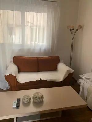 a living room with a couch in front of a window at Athenian cozy Apartment!!! By Gela in Athens