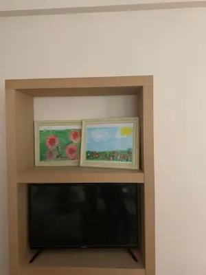 two paintings of flowers on a shelf in a room at Athenian cozy Apartment!!! By Gela in Athens