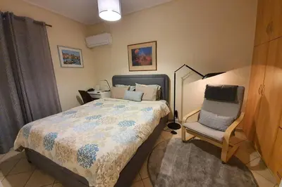 a bedroom with a bed and a chair at CLOVER 3m to panormou metro station in Athens