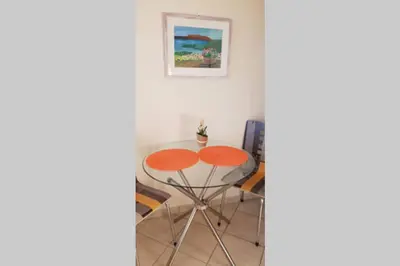 a table and chairs in a room at CLOVER 3m to panormou metro station in Athens