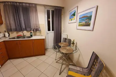 a kitchen with a glass table and a sink at CLOVER 3m to panormou metro station in Athens