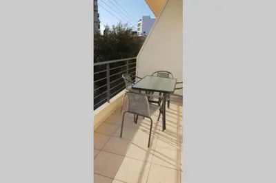 a small table on the balcony of a house at CLOVER 3m to panormou metro station in Athens
