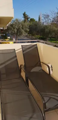 a black chair sitting on top of a roof at CLOVER 3m to panormou metro station in Athens