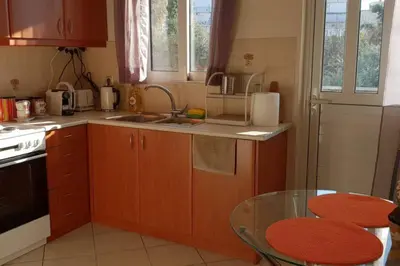 a kitchen with a sink and a table in it at CLOVER 3m to panormou metro station in Athens