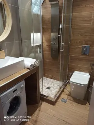 a bathroom with a shower and a toilet and a sink at VARKIZA VIEW APARTMENT in Varkiza