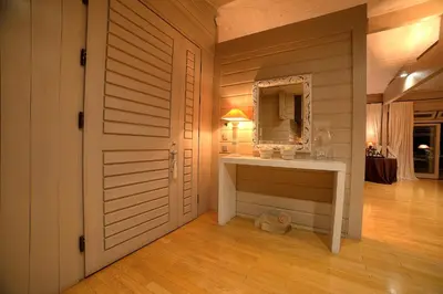 a bathroom with a vanity and a mirror next to a door at LYCIPONON Villa in Anavissos