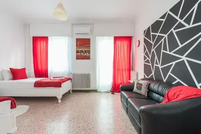 a living room with a couch and a bed at Private Rooms Athens - Shared Bathroom in Athens