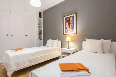 two white beds in a room with a lamp at Private Rooms Athens - Shared Bathroom in Athens