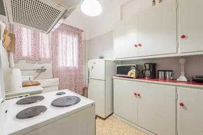 a kitchen with a stove and a white refrigerator at Private Rooms Athens - Shared Bathroom in Athens