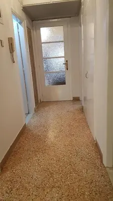 an empty hallway with a door and a window at Teal Apartment - Athens Center, 4 BD, 2 BATH in Athens