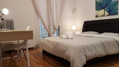 a bedroom with a bed with two pillows on it at Teal Apartment - Athens Center, 4 BD, 2 BATH in Athens