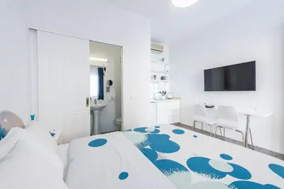 a bedroom with a bed with a blue flower carpet at Blue Couple House Athens in Athens