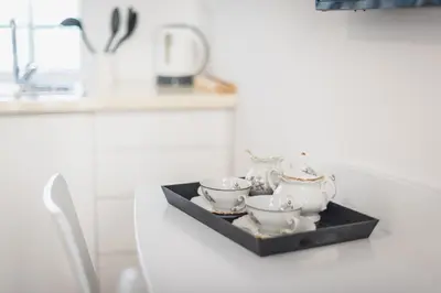 a tray with four tea sets on a kitchen counter at Blue Couple House Athens in Athens