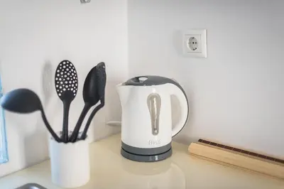 a black and whiteffeepot sitting on a counter at Blue Couple House Athens in Athens