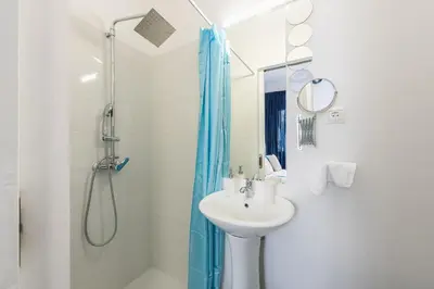 a bathroom with a sink and a shower at Blue Couple House Athens in Athens