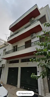 a building with two garage doors and two gates at Blue Couple House Athens in Athens