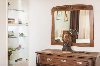 a mirror on top of a dresser in a room at Sophisticated Family House With Acropolis View in Athens