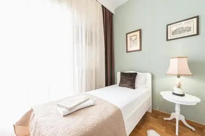 a bedroom with a bed and a table with a lamp at Sophisticated Family House With Acropolis View in Athens