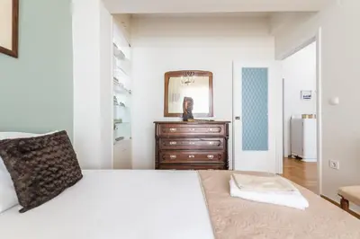 a bedroom with a bed and a dresser and a mirror at Sophisticated Family House With Acropolis View in Athens