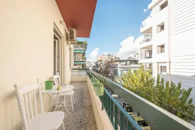 a balcony with a table and chairs on a building at Sophisticated Family House With Acropolis View in Athens