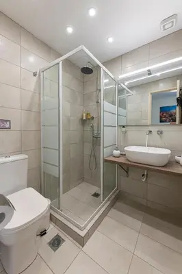 a bathroom with a shower and a toilet and a sink at Athens Plaka House in Athens