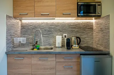a kitchen with a sink and a microwave at Athens Plaka House in Athens