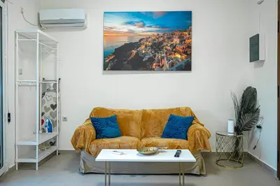 a living room with a couch and a table at Athens Plaka House in Athens