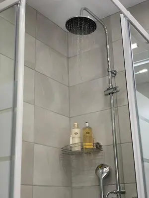 a shower with two soap bottles on a shelf at Athens Plaka House in Athens
